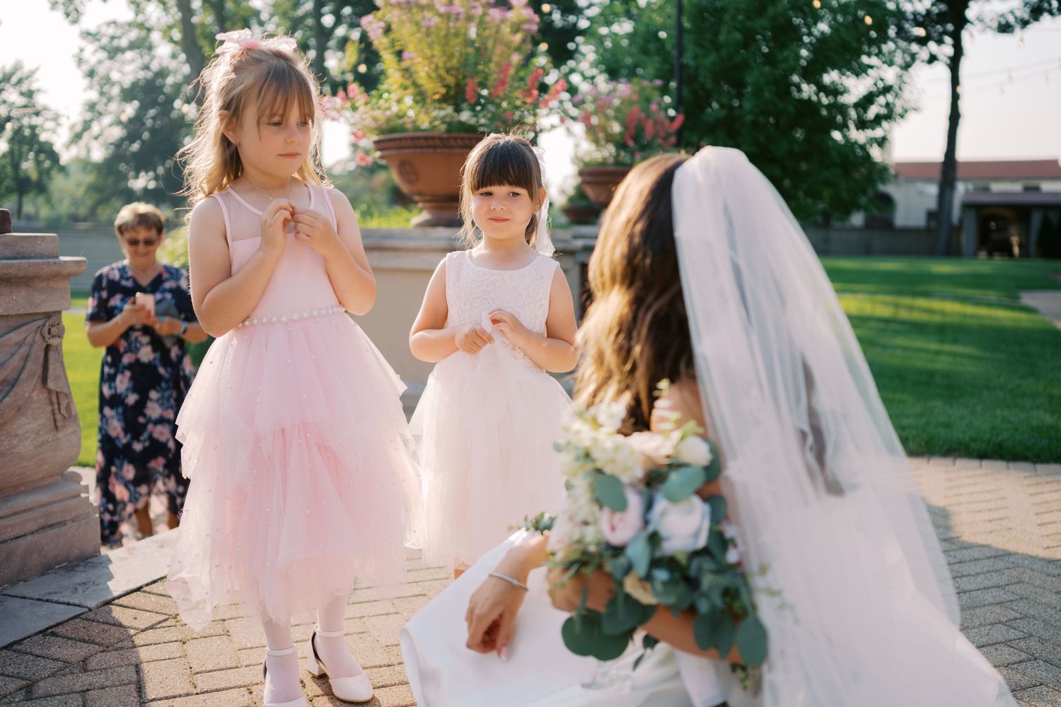 A collection of wedding photos showing a flower girl in a pink tulle dress at an outdoor celebration.