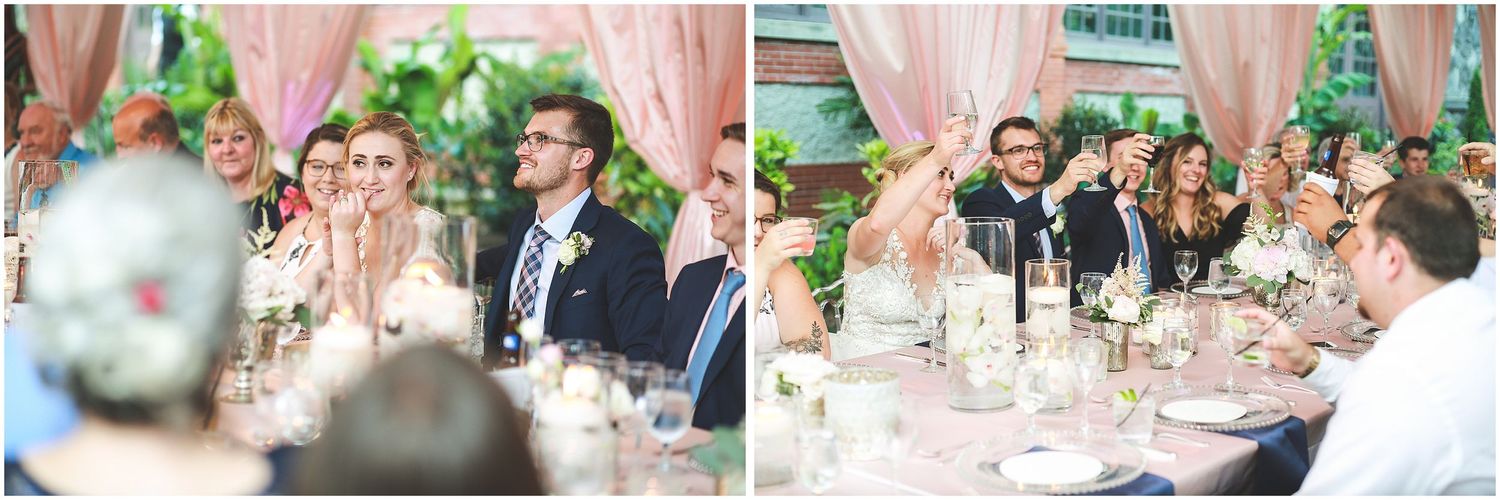 Elegant outdoor wedding reception with pink and white decor, featuring long tables set under trees in a garden setting.