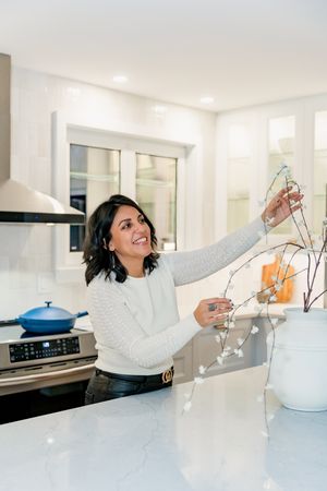 A series of photos showing someone reaching dramatically across a white kitchen counter to grab something out of frame.