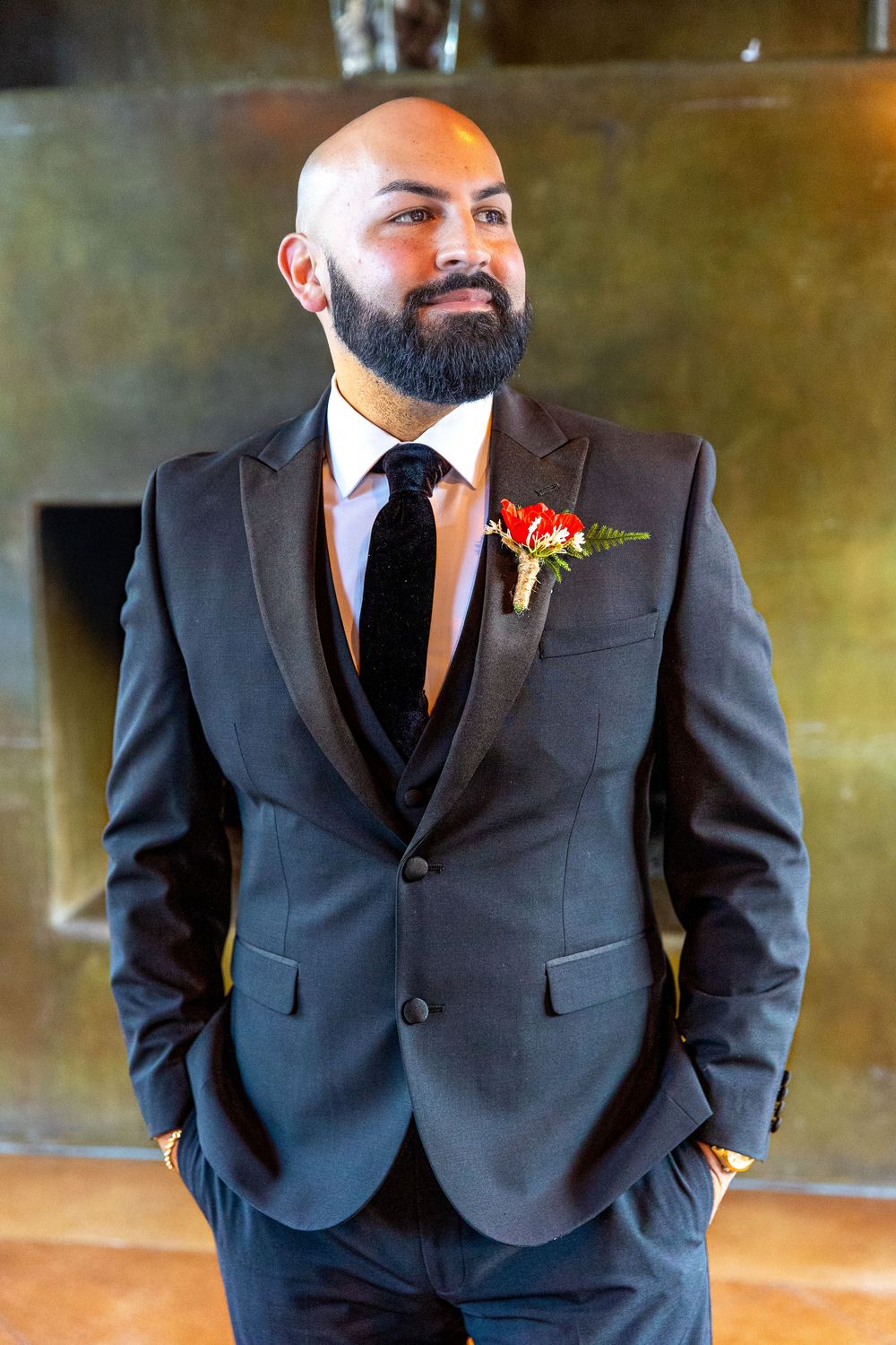 A person wearing a dark suit and tie poses in a sequence of close-up shots showing the formal attire details.