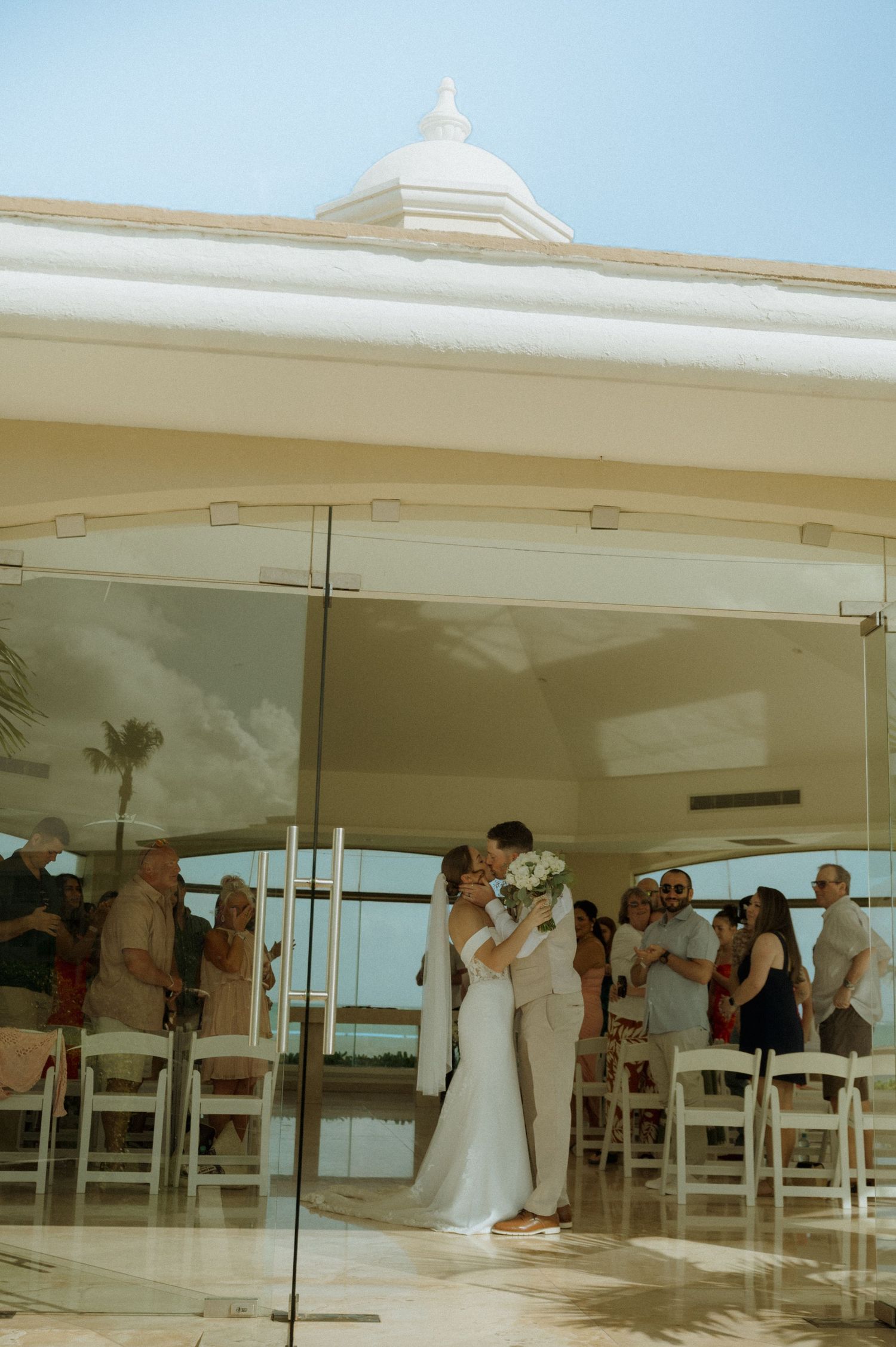 Panoramic sequence showing a wedding ceremony taking place in a modern white chapel with ocean views.