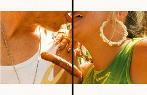 Woman in green dress and gold jewelry dances during golden hour with light reflecting off her accessories.