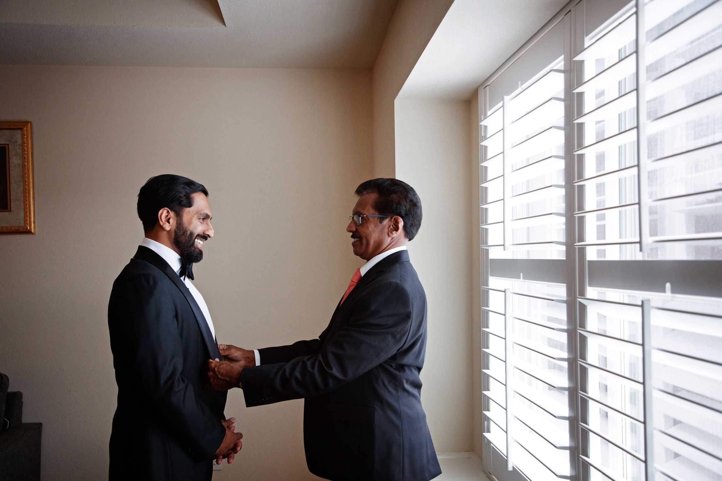 groom with father getting ready before ceremony