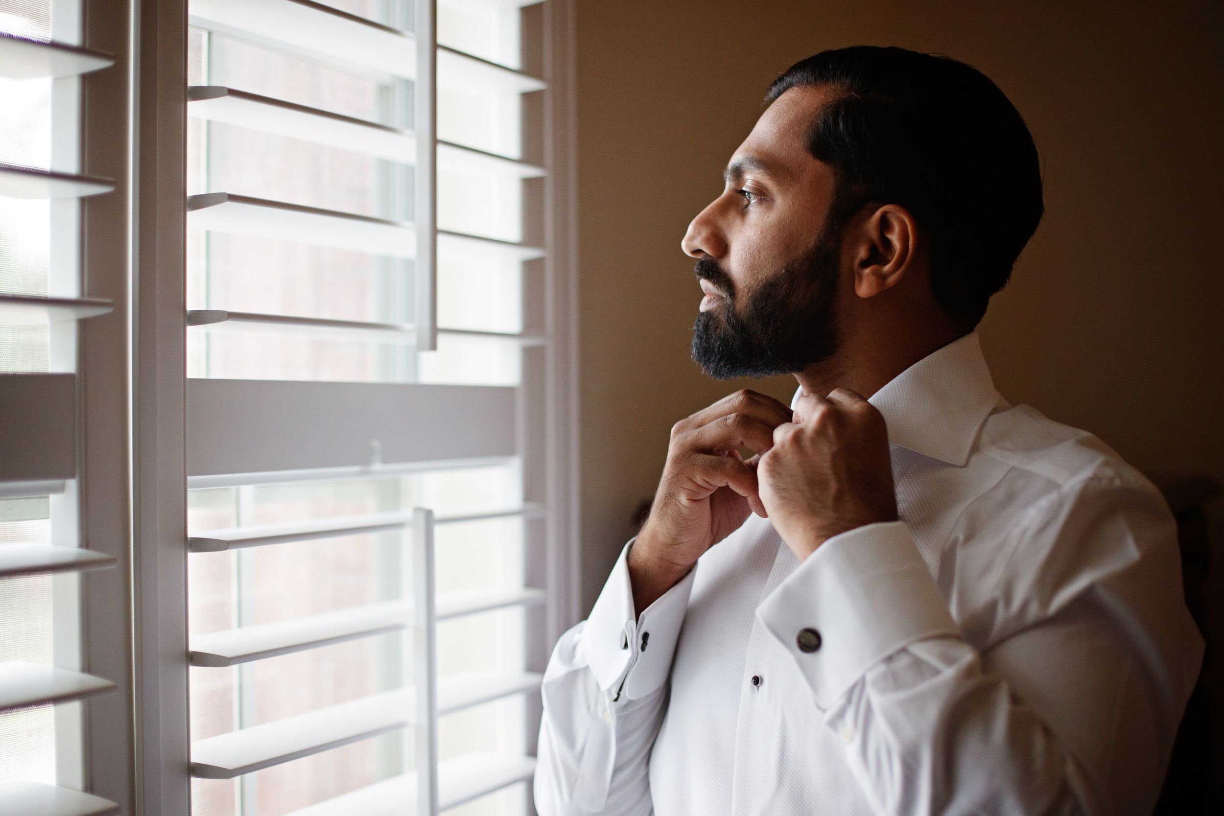 candid groom moment before wedding ceremony