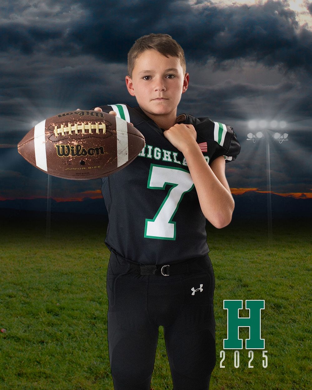 Youth football player poses in black uniform with green number 7 against dramatic stormy sky backdrop.