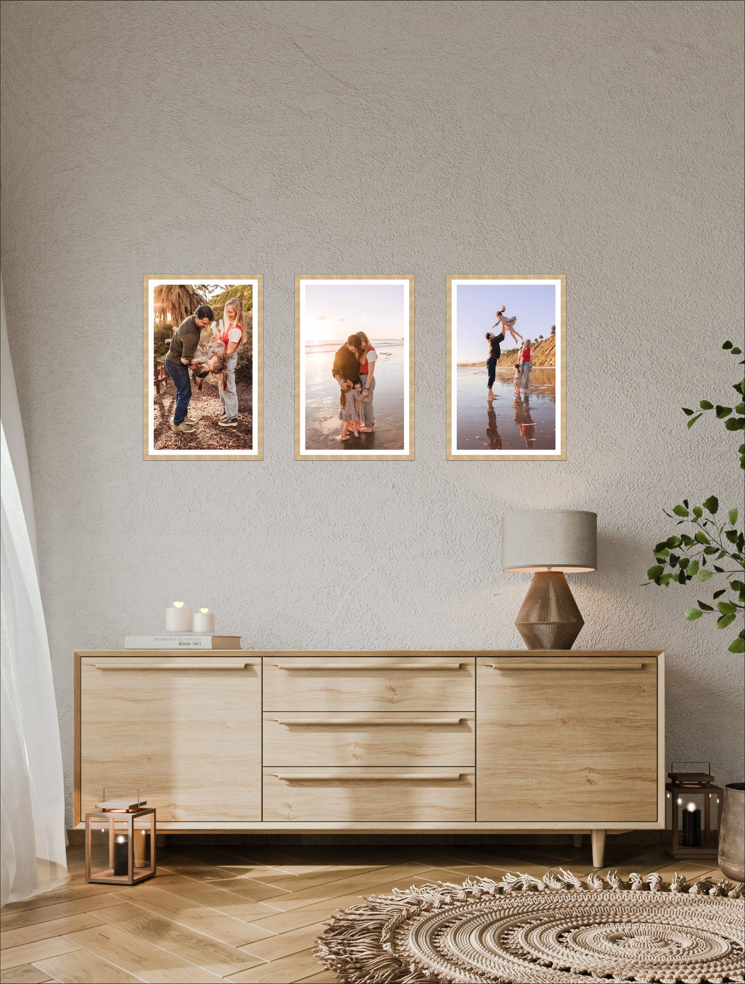 Modern living room interior with three framed photographs above a wooden sideboard, decorated with plants and lanterns.