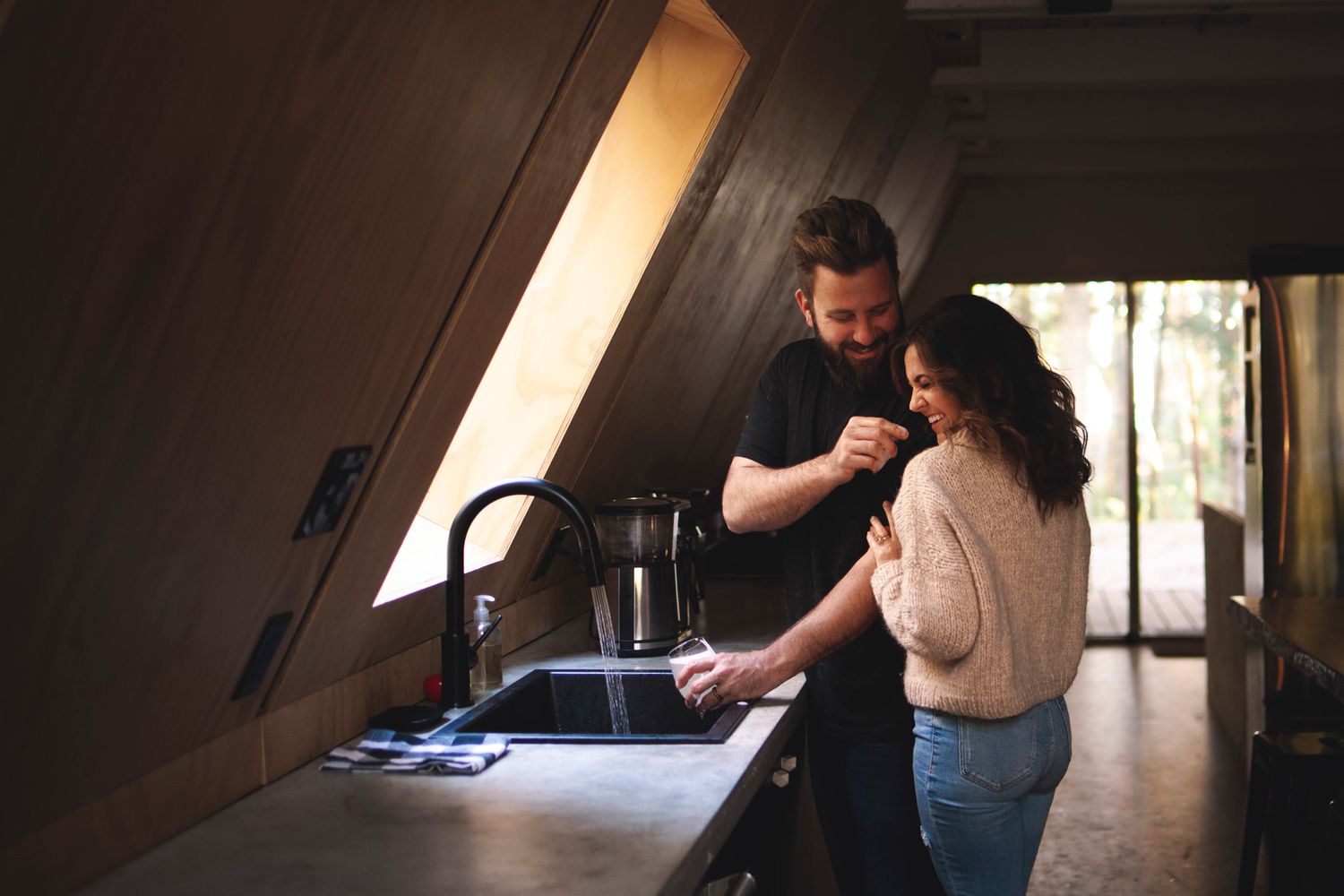 visiting couple has playful portraits taken B&B kitchen near thousand islands ontario