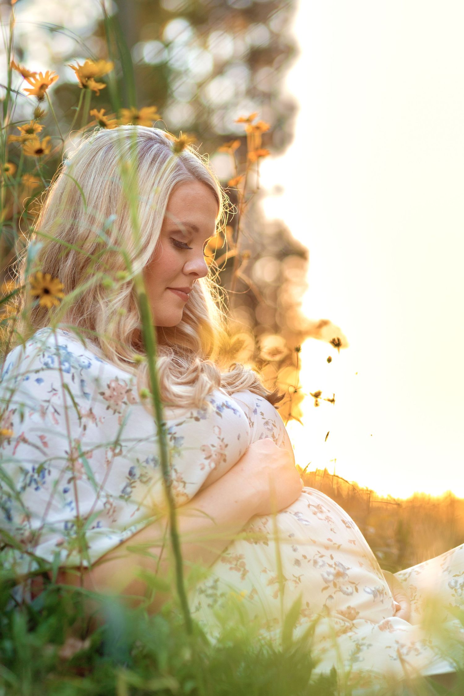 Dreamy outdoor portrait in golden sunlight with autumn leaves falling through soft bokeh effect.