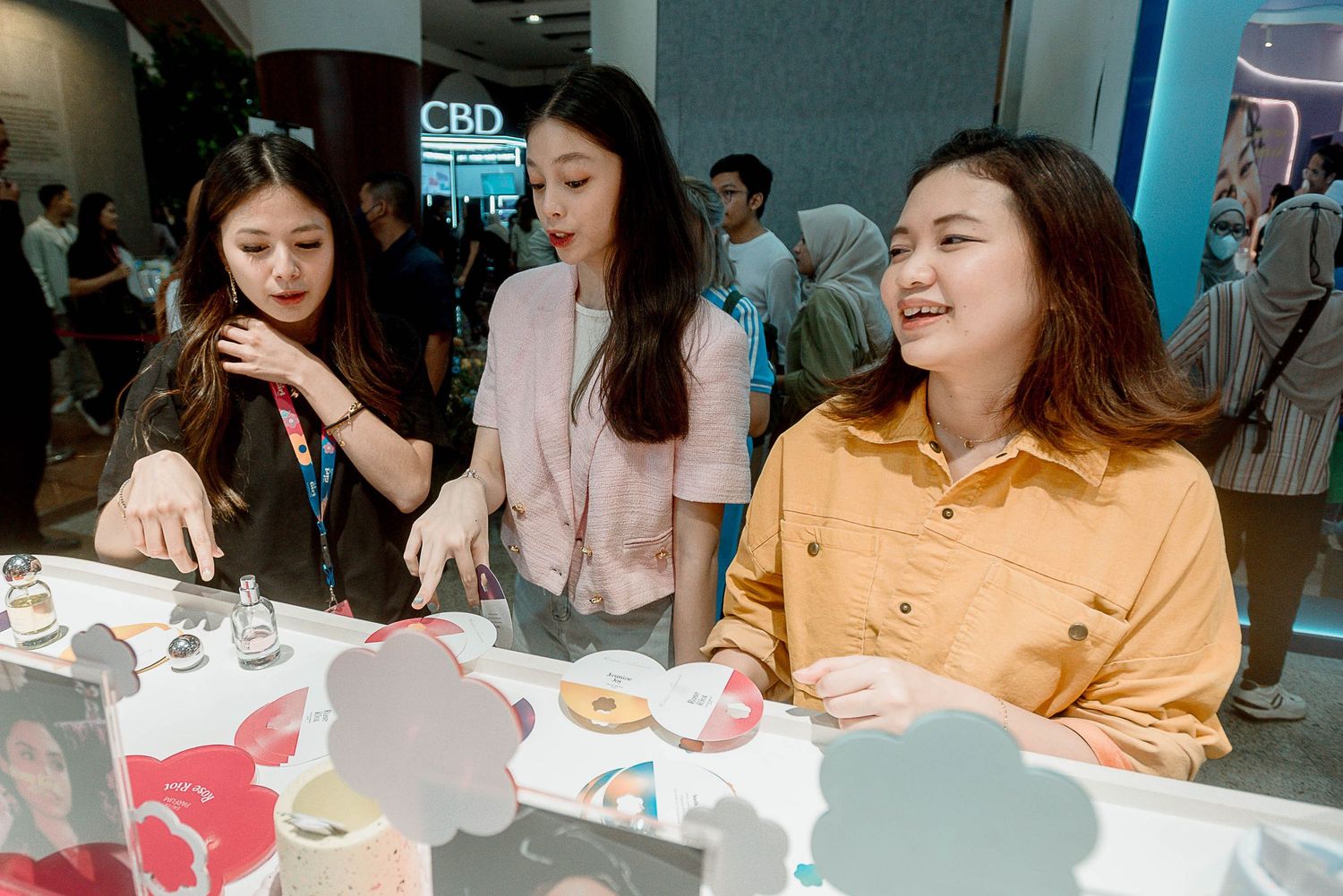 People gathered around a table enjoying food and drinks at a casual social gathering.