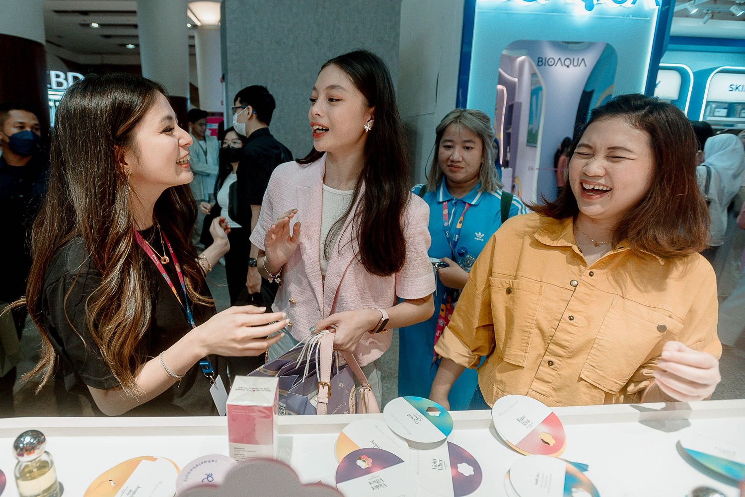 A group of people enjoy a social gathering at a cafe or restaurant with drinks and conversation.