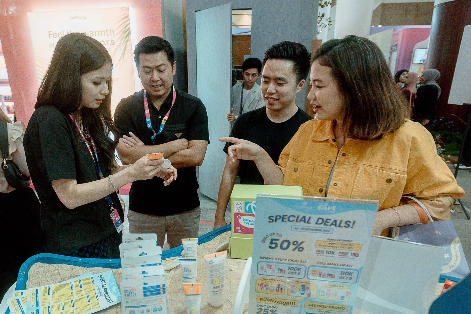 A group of people gather around tables playing board games and card games in a casual social setting.