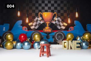 Racing themed party setup with trophy, checkered flags, and gold and blue balloons against dark backdrop.