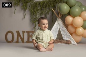 Boho themed party setup with teepee tent, balloon arch and wooden ONE letters.