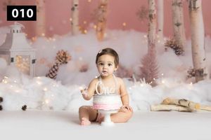 Winter wonderland themed photography setup with pink backdrop and birch trees.