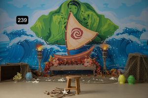 Ocean themed photo backdrop with painted waves and green sea creatures for children's photography.