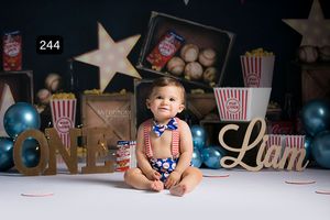 Movie theater themed photo setup with popcorn props and gold star decorations.