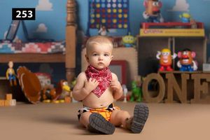 Toy Story themed photography set with blue walls and classic childhood toys.