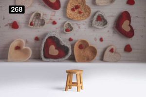 Wooden stool against backdrop of heart-shaped cookies and Valentine's Day decorations.