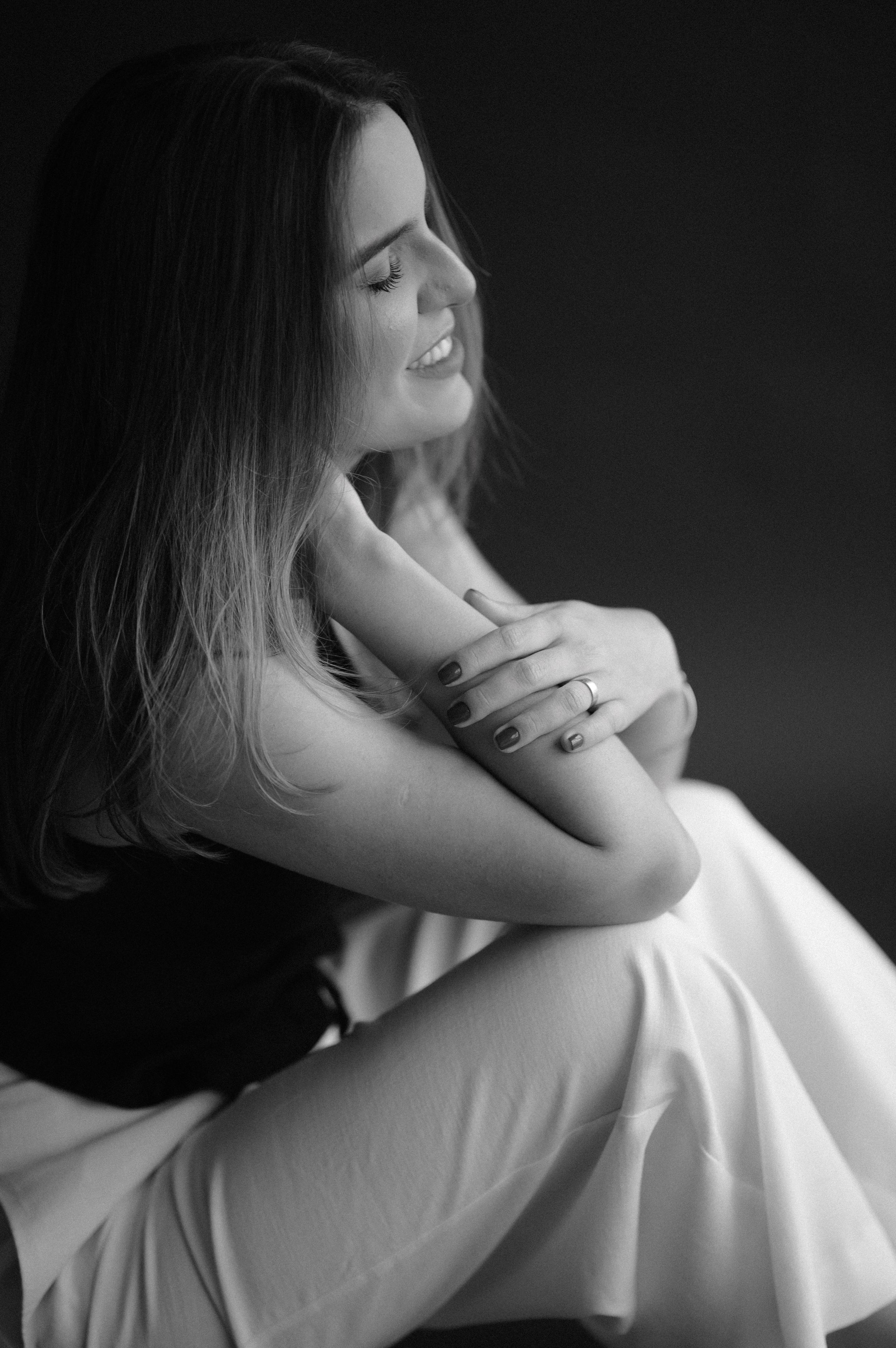 Intimate black and white portrait with soft lighting and dreamy expression.