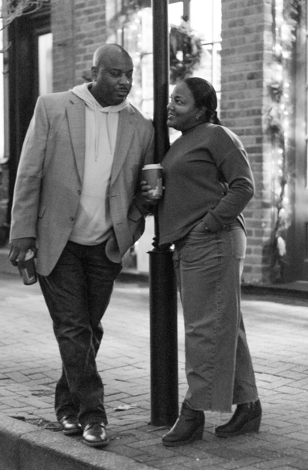 People walking together on a brick sidewalk in casual attire.