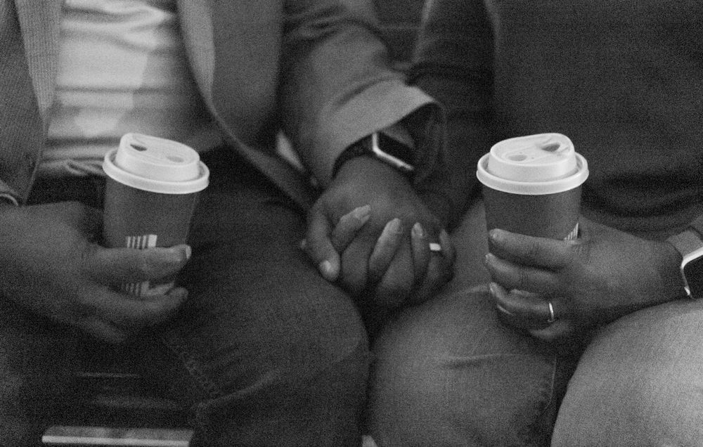 Multiple coffee cups being held during a casual meetup.