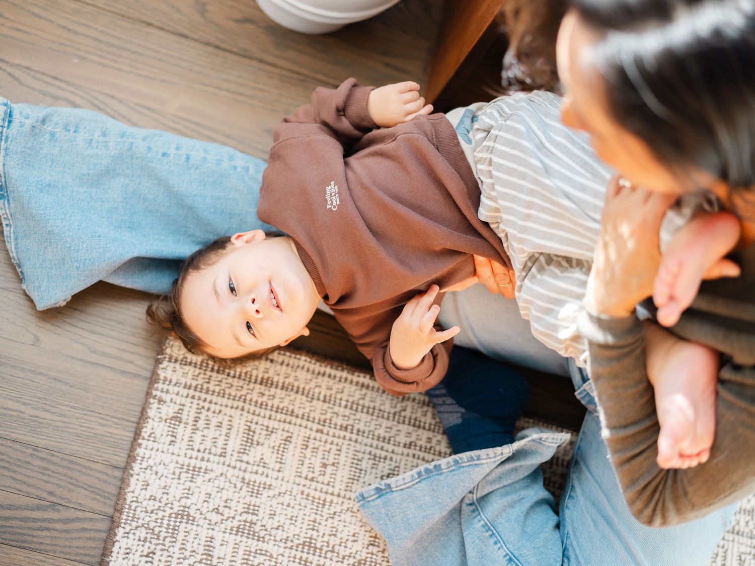 Cozy at-home family photography capturing quiet connection between mother and son in Monmouth County, NJ.