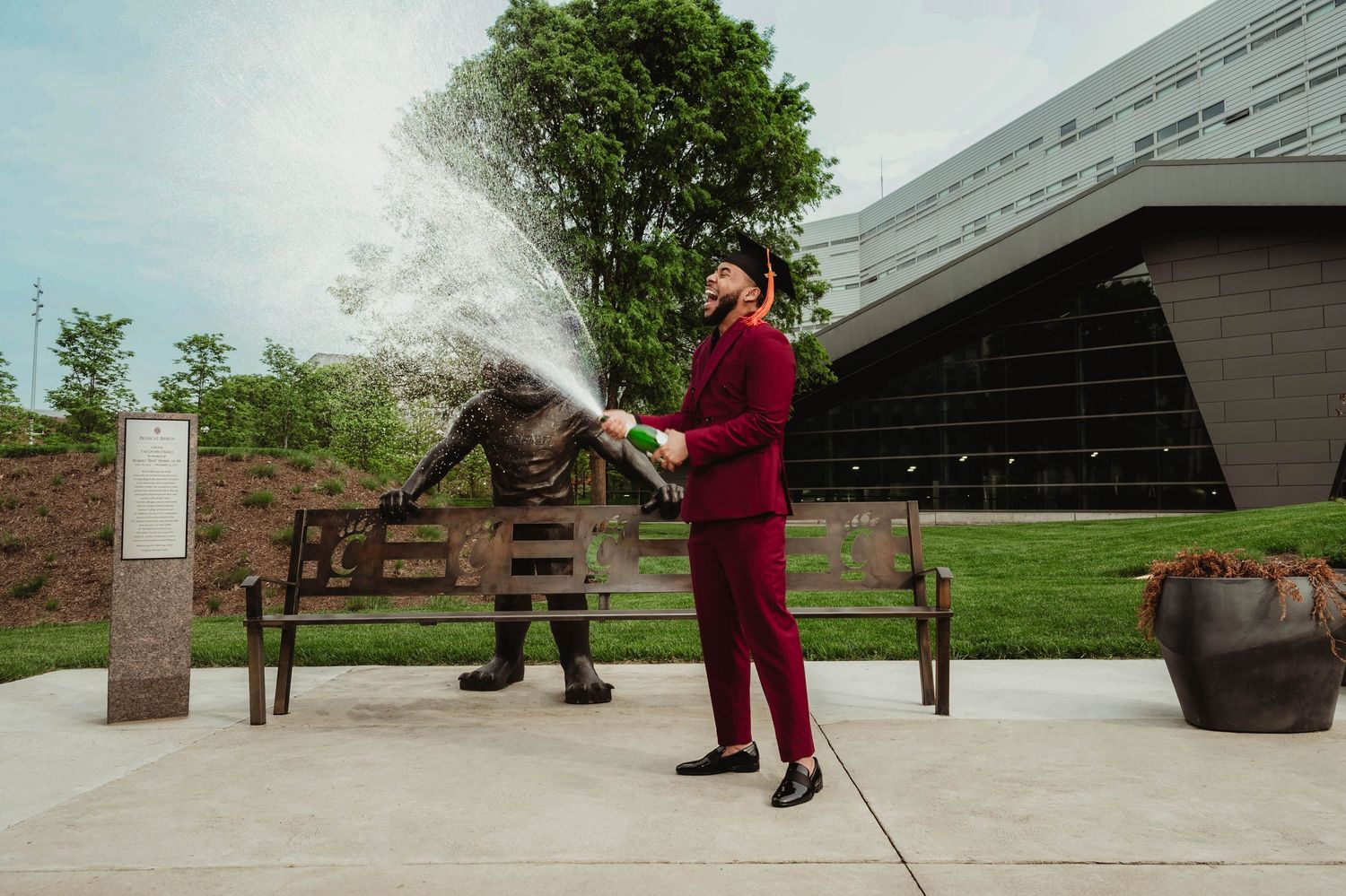 A series of connected images showing someone in red clothing performing various movements near a building.