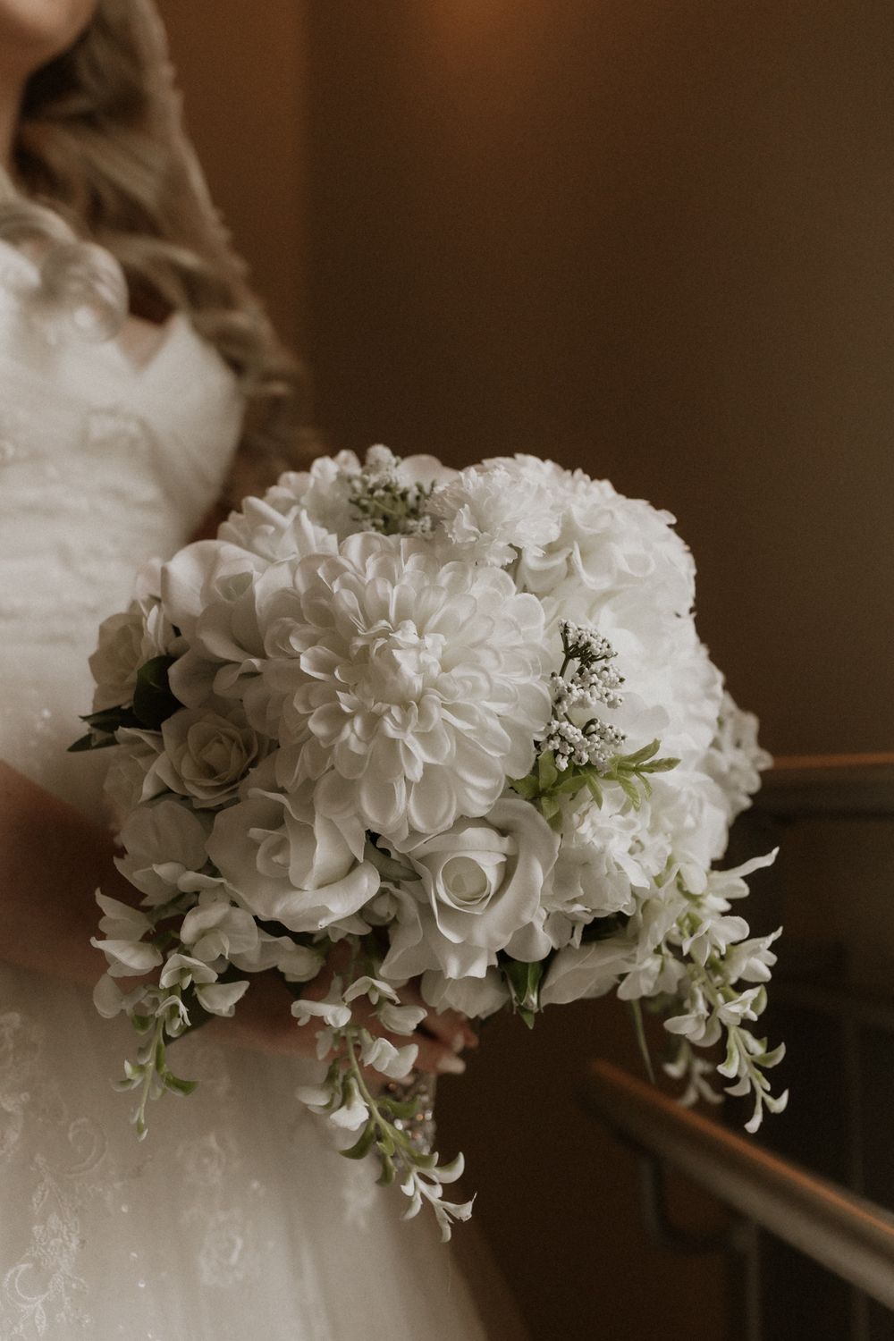A series of elegant white floral arrangements featuring hydrangeas and roses against a dark background.