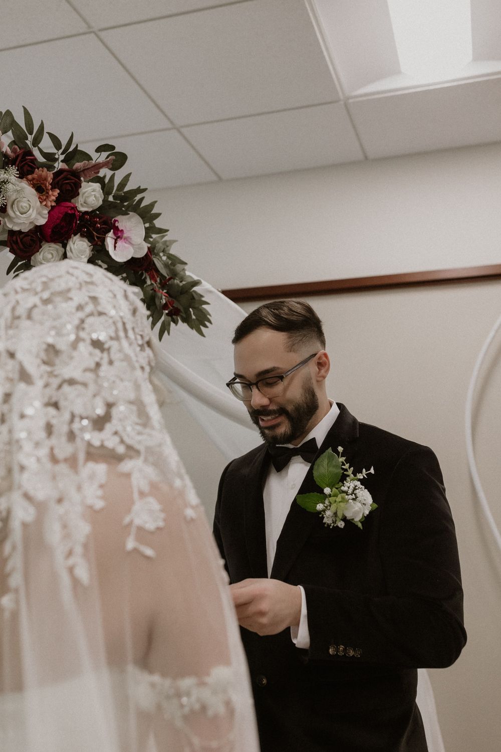Emotional first look moment at wedding as couple sees each other in elegant wedding attire.