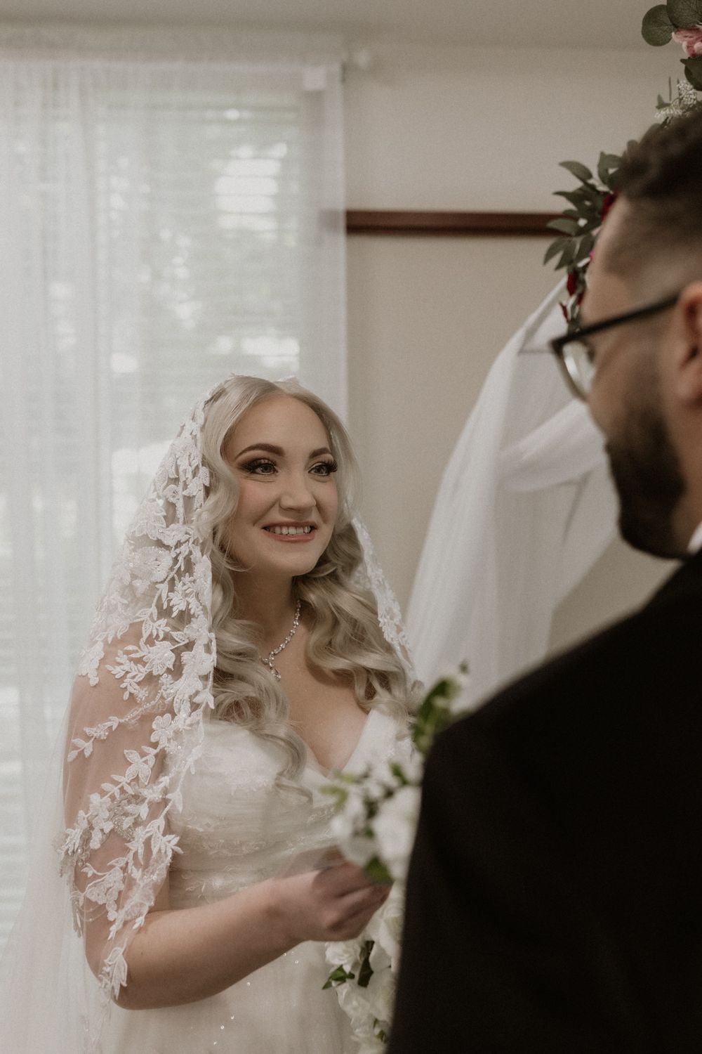 A series of intimate wedding photos showing tender moments between a bride in a lace veil and her partner.