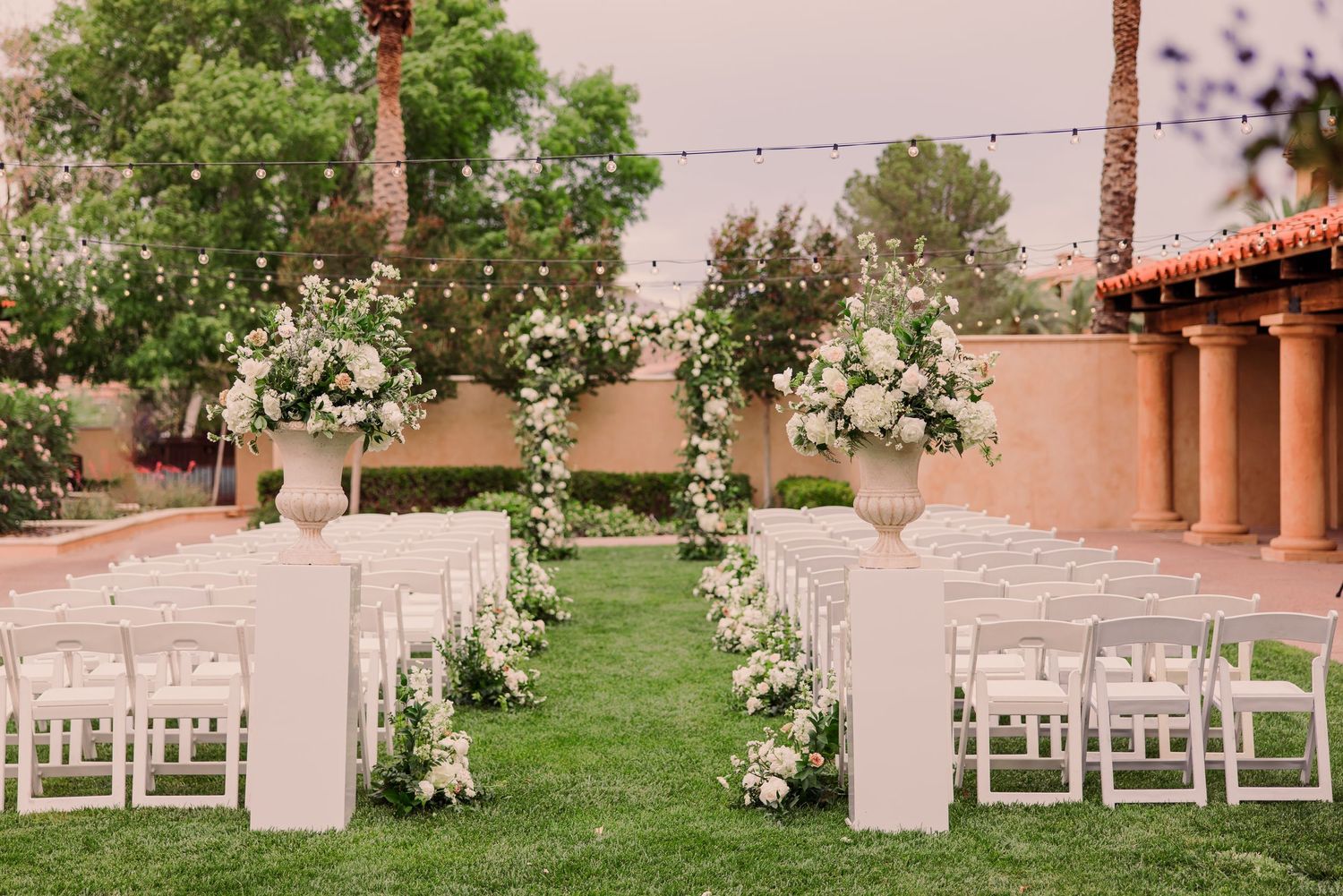 Black and white wedding photos showing a bride in a flowing white dress with a long veil in an elegant hallway setting.