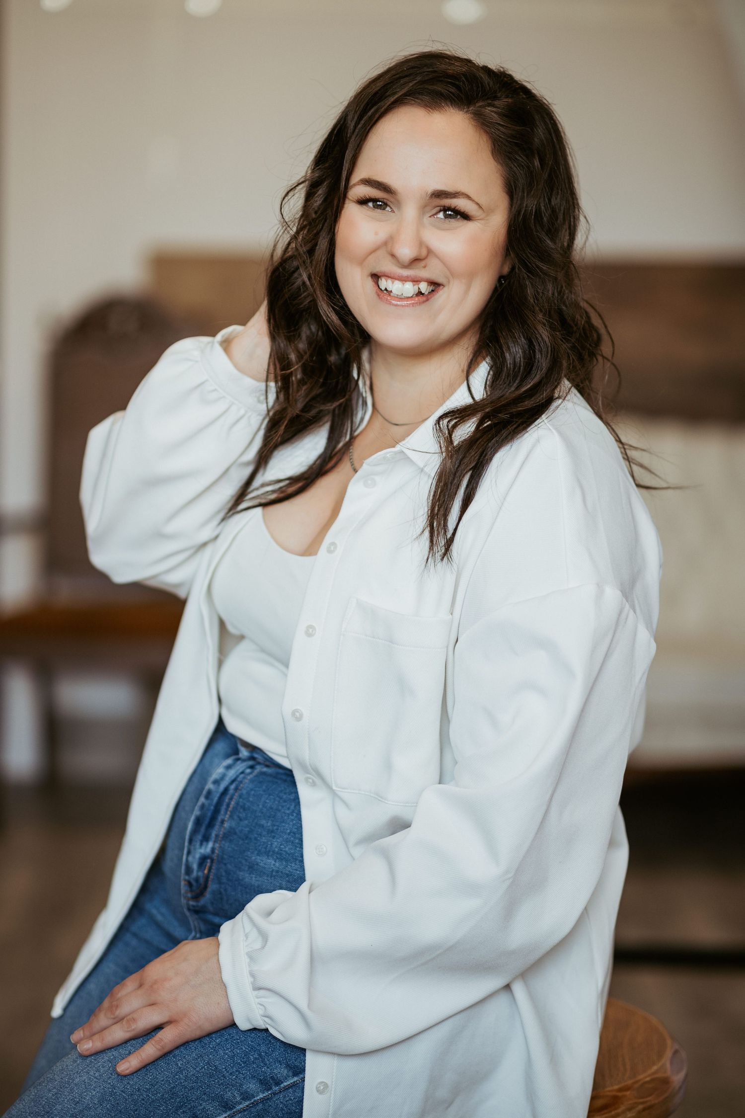Casual portrait of person in white shirt and jeans.