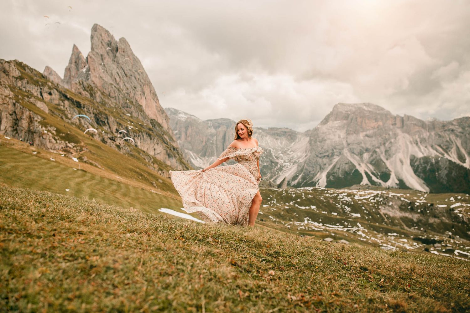 A series of panoramic mountain landscapes showing rugged peaks and grassy slopes in the Dolomites during sunset.