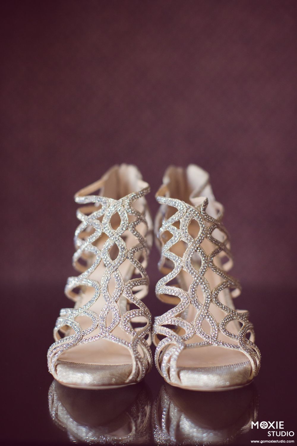Elegant silver rhinestone-encrusted bridal sandals photographed in sequence against a dark purple background.