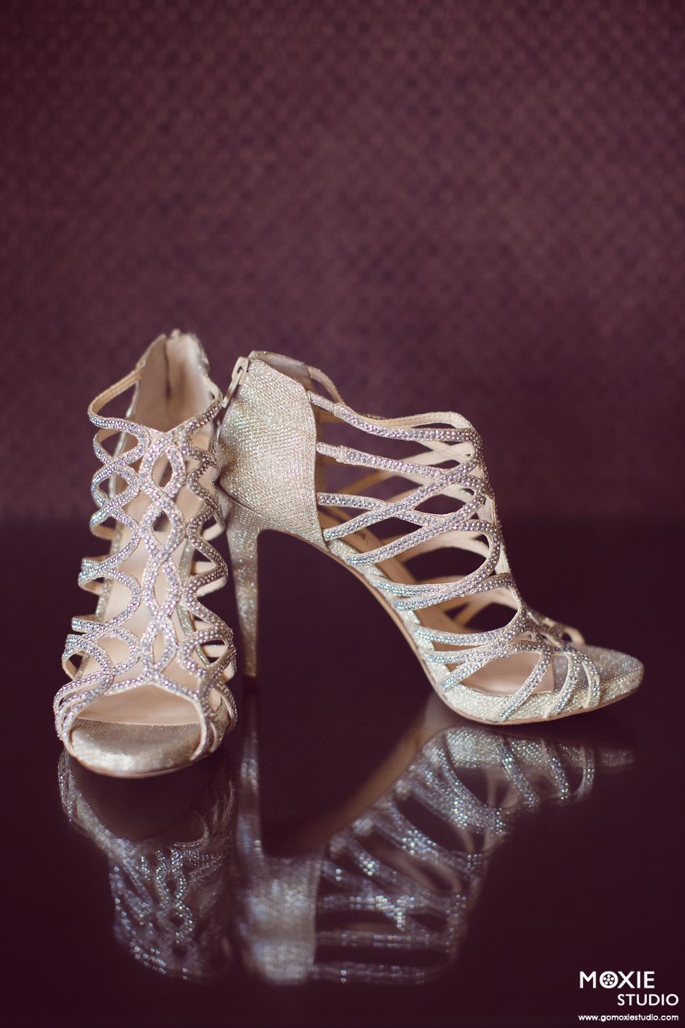 A sequence of sparkly silver wedding heels shown at different angles on a dark background with studio lighting.