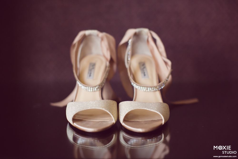 A series of elegant beige wedding shoes photographed in different angles on a dark background.