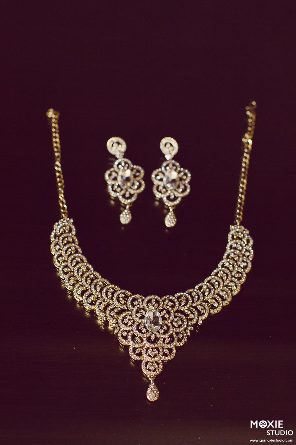 Elegant gold and diamond necklace set with intricate filigree design displayed in sequence on dark background.