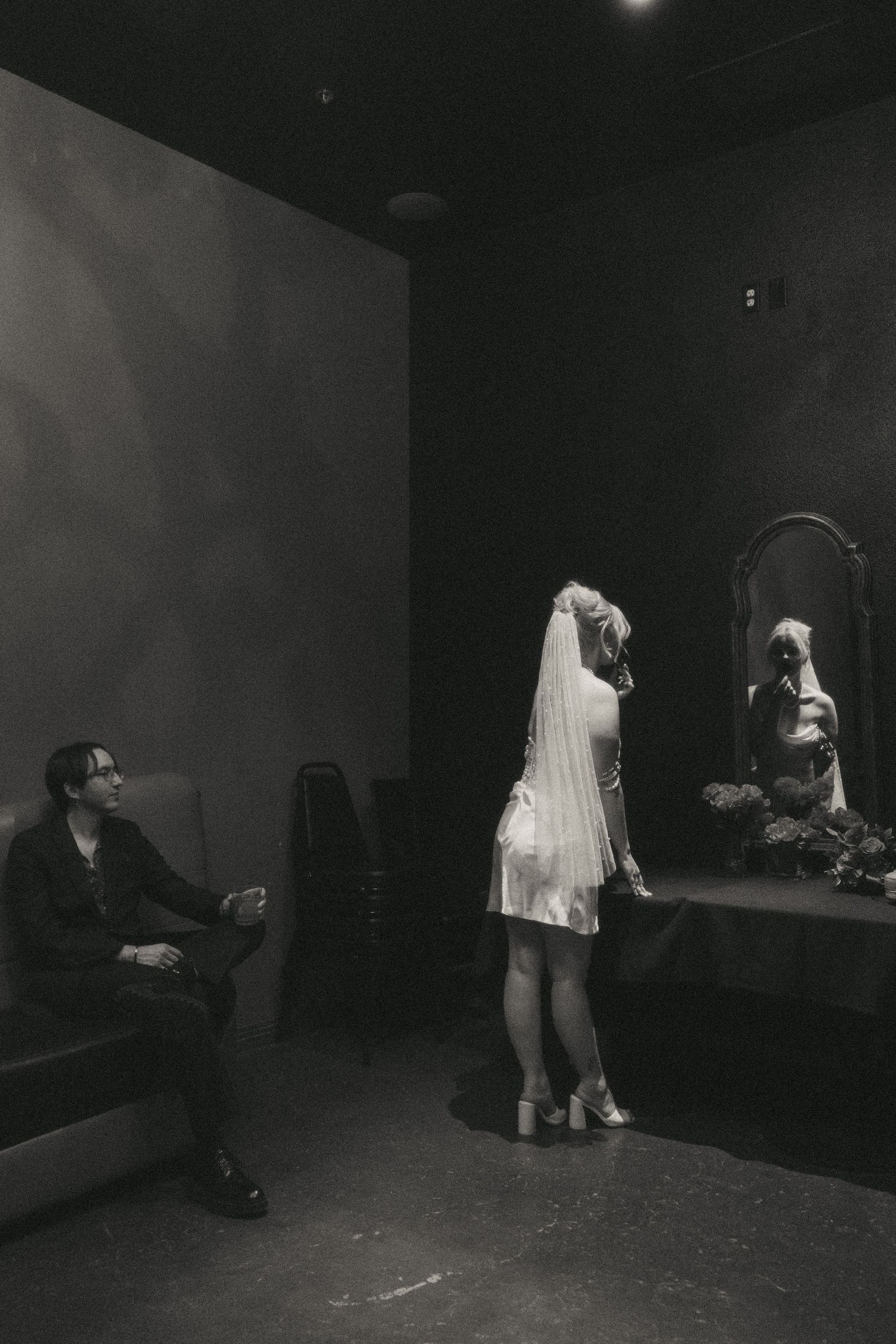 A series of black and white performance photos showing dancers in motion on a dark stage.