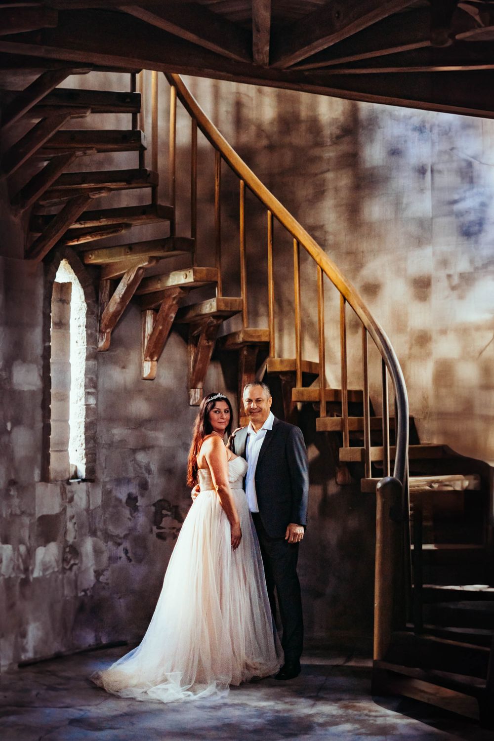 Photography session at Castle Ottis Vero Beach Florida. Wedding photo under a spiral staircase.