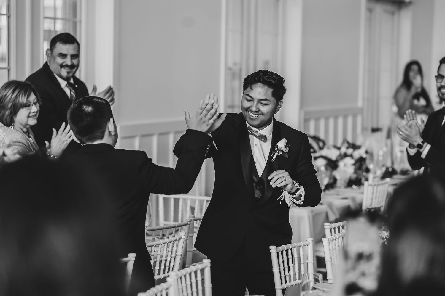 Guests dancing and celebrating under reception lighting