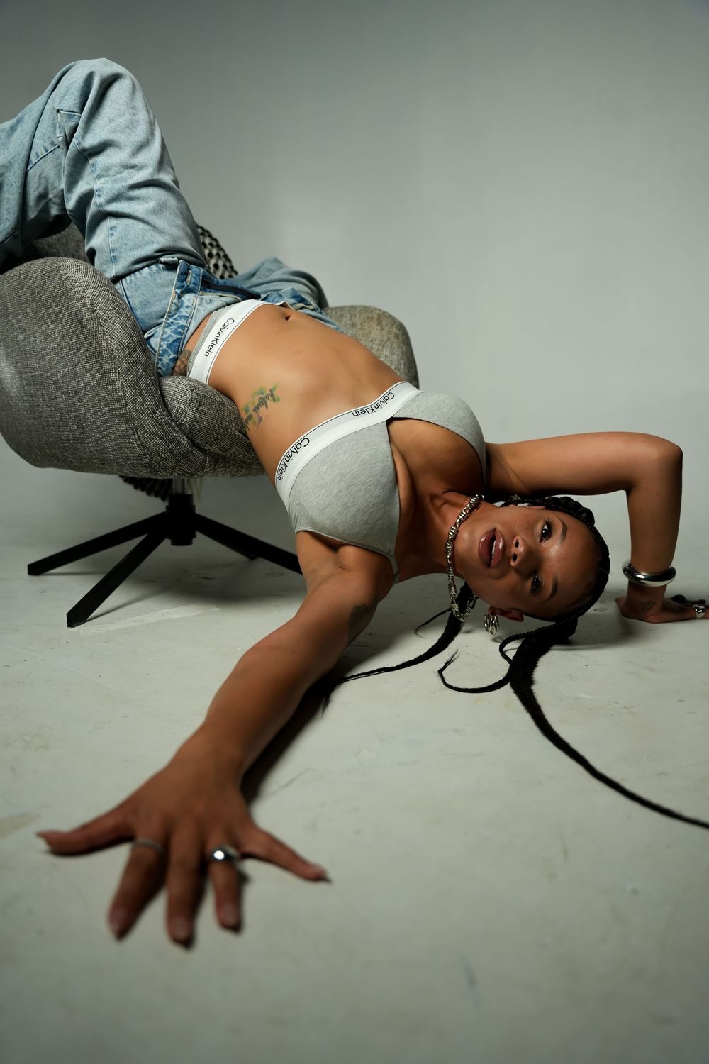 Sequential photos showing someone lying on a gray floor in casual clothing.