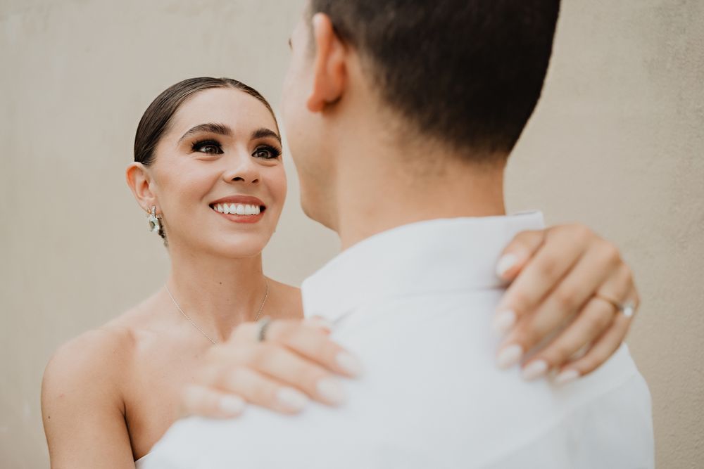 Bride smiling at her partner, a candid moment filled with warmth and affection