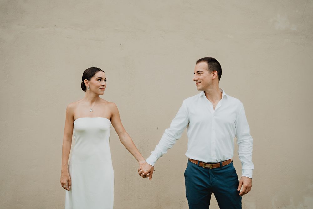 The couple holding hands, locking eyes with love and tenderness