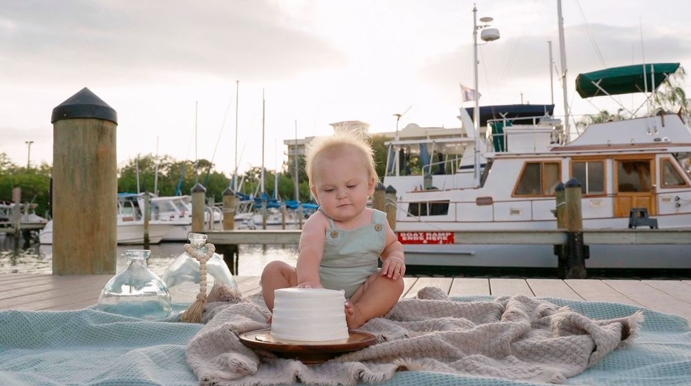 One year old touching cake for the first time