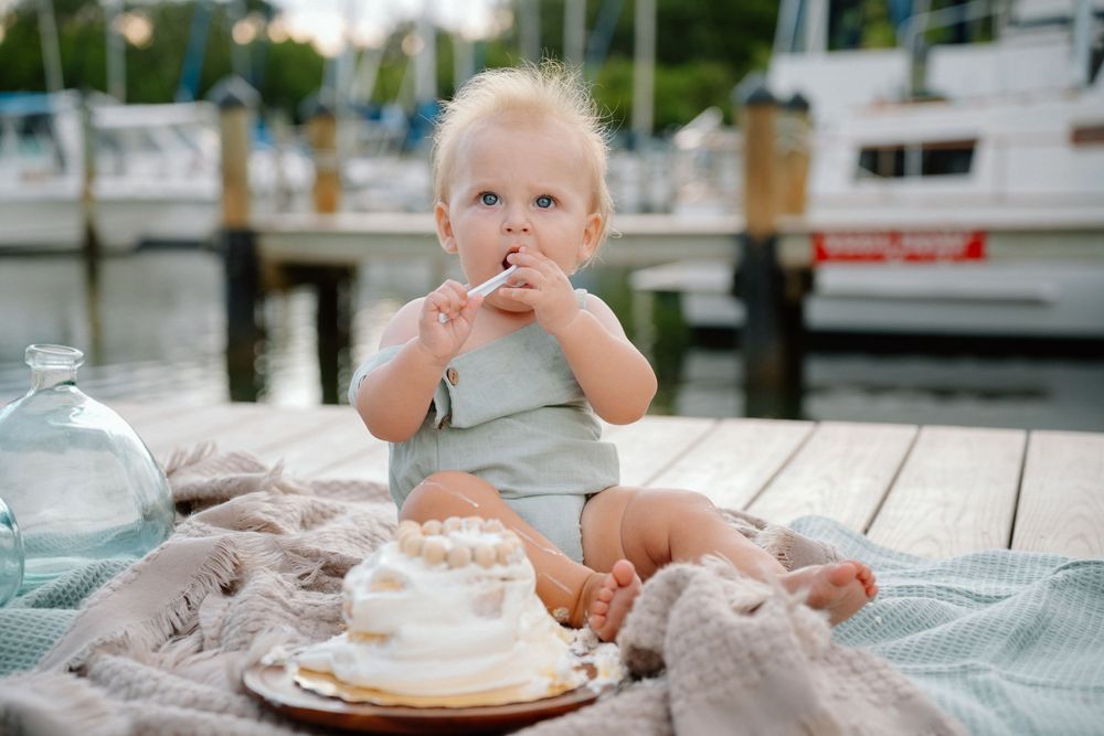 One year old eating smash cake