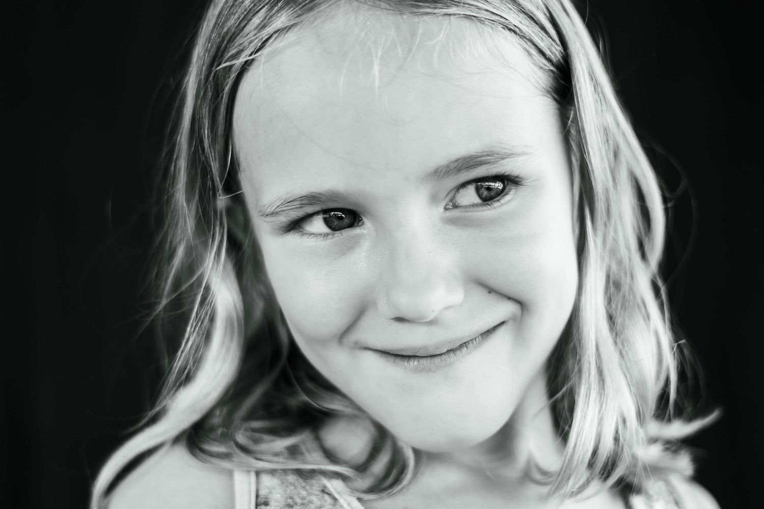 Silly girl with a shy smile during daycare preschool graduation portraits in palm bay florida