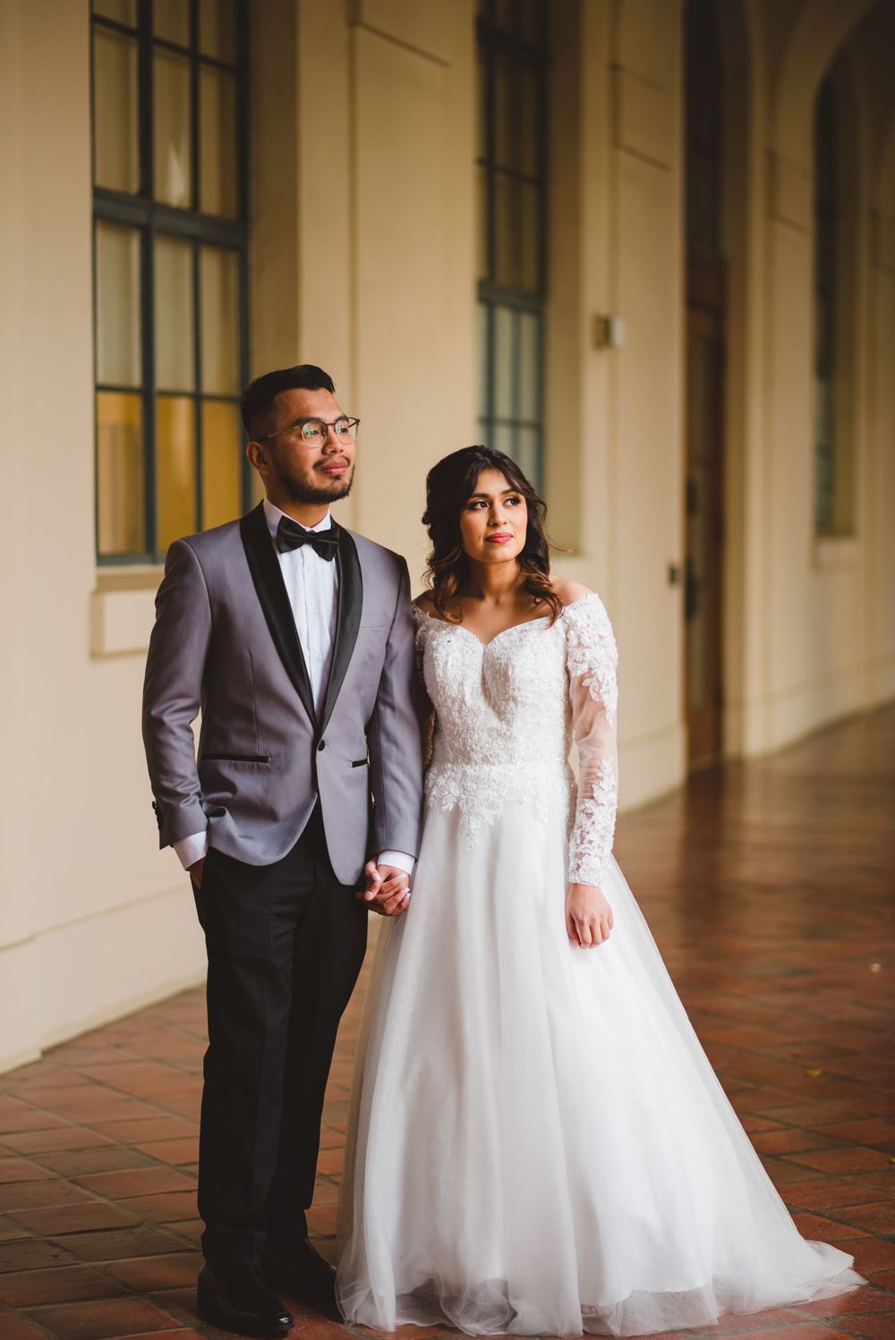 At Pasadena City Hall, the bride and groom exchange loving glances as they pose for their wedding photos.