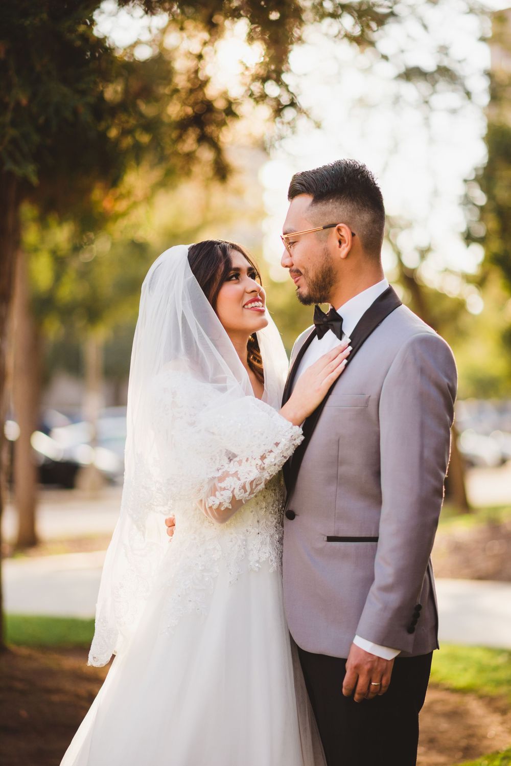 At Pasadena City Hall, the bride and groom walk hand in hand, their wedding photos reflecting their love.