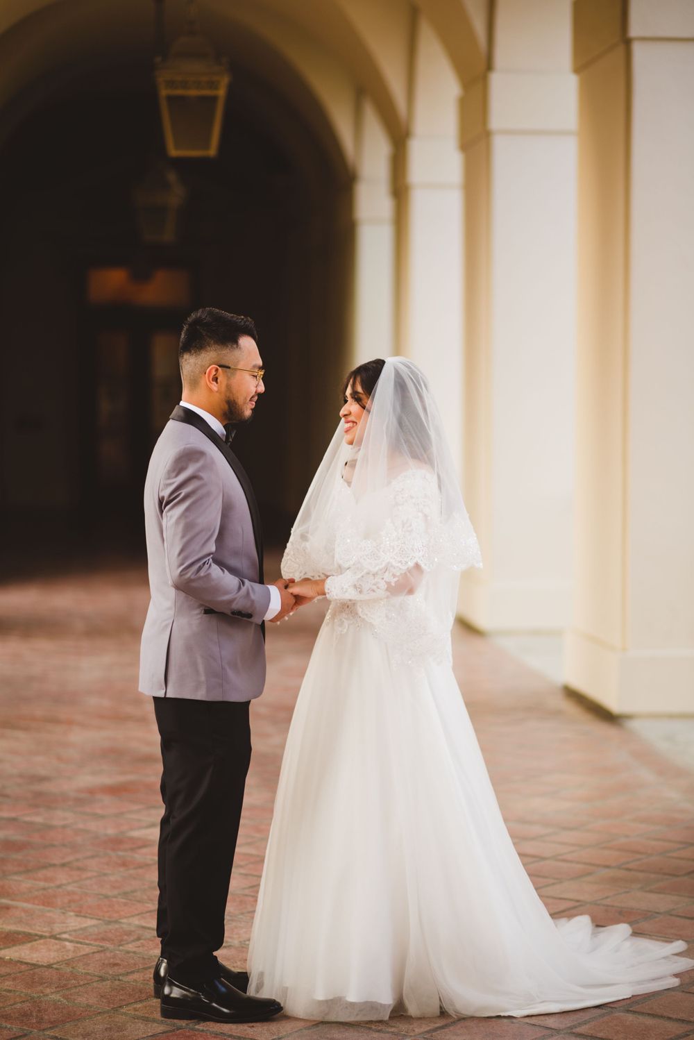 At Pasadena City Hall, the bride and groom exchange loving glances as they pose for their wedding photos.