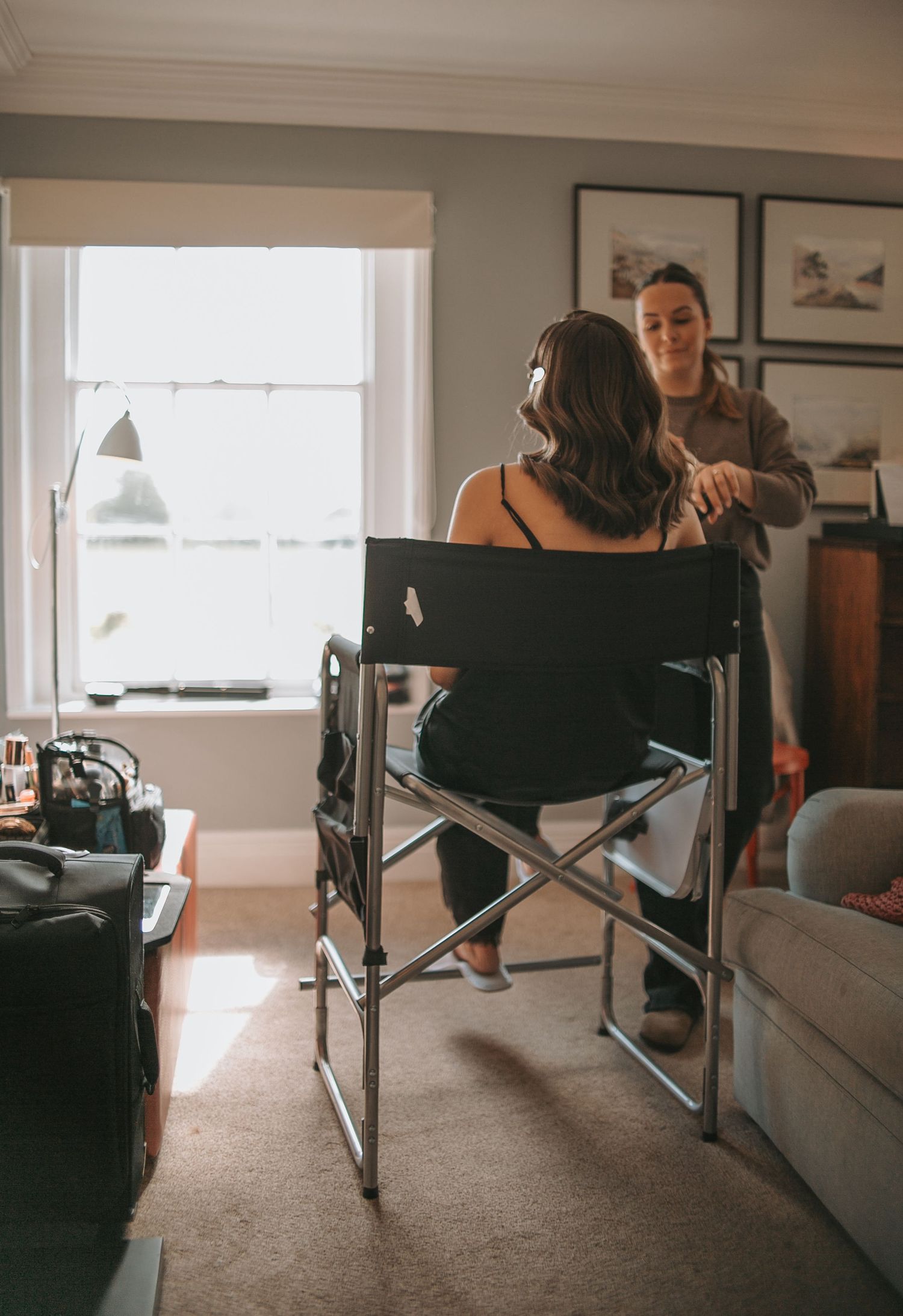 Wedding preparation scene with folding chairs arranged in a sunlit room.